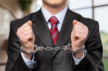 Handcuffed person in a suit