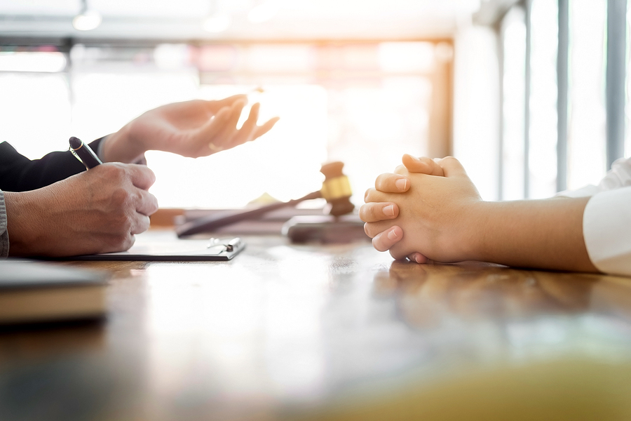 Lawyer explaining legal documents to a client during a consultation in a professional office.